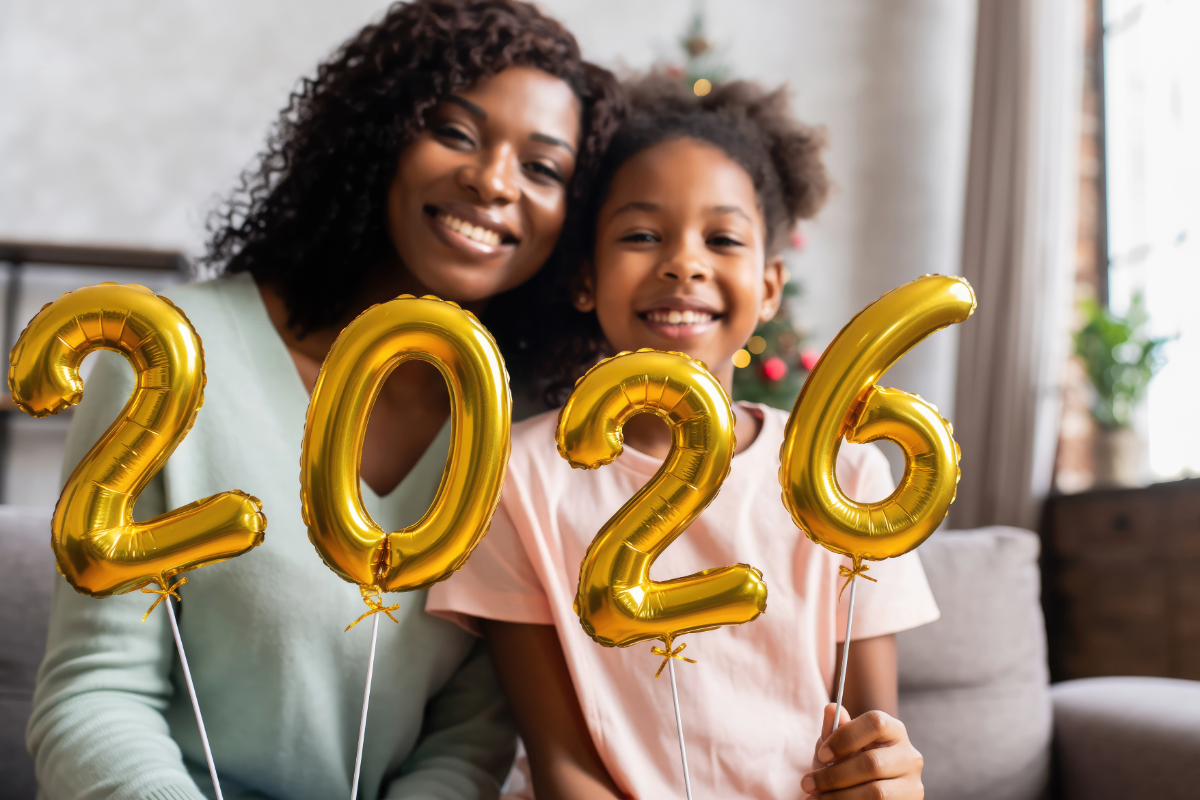 Mother and daughter holding up ballons for 2026